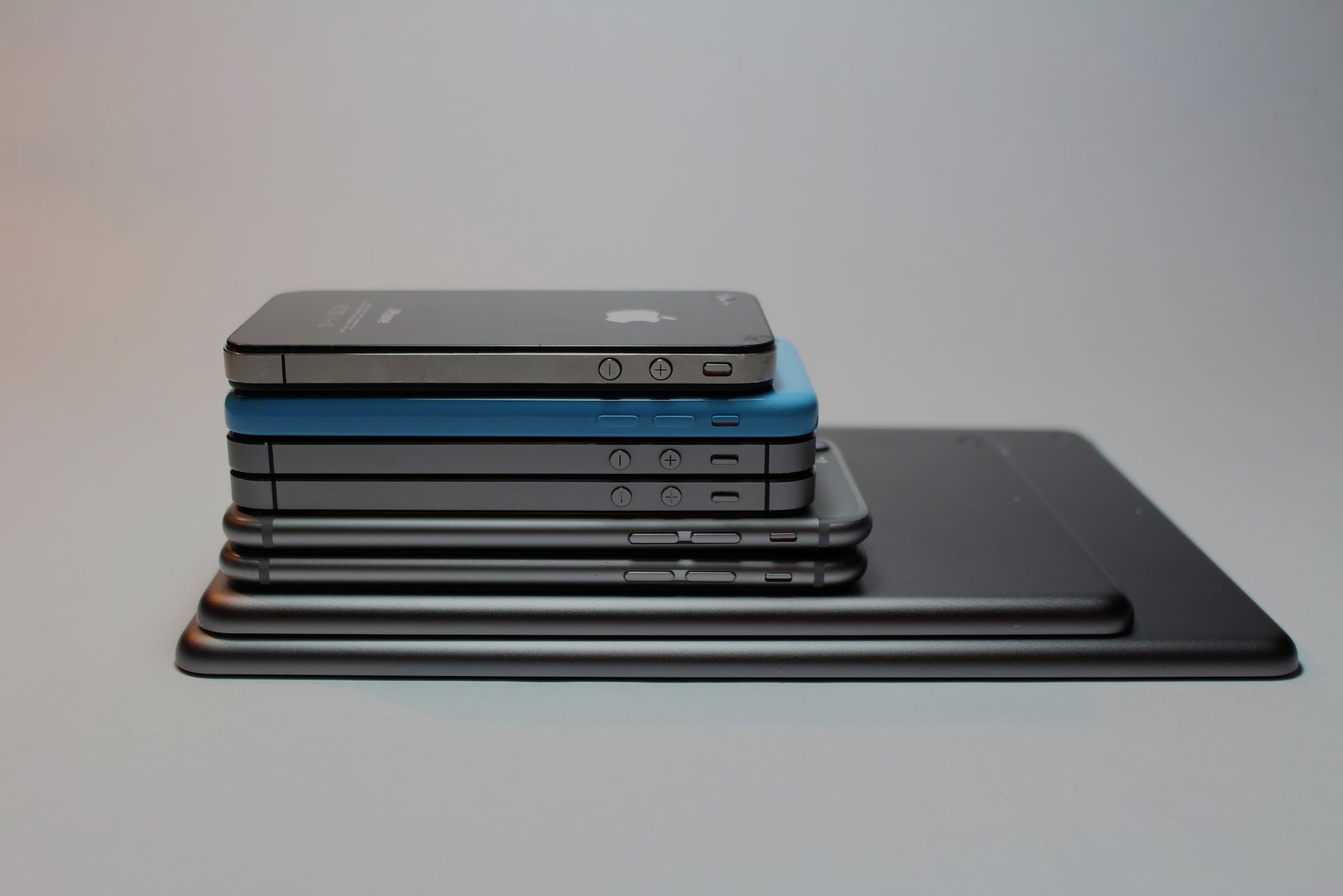 picture of ipads and iphones stacked on top of each other